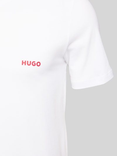 Männermodel trägt T-Shirt mit Label-Print im 3er-Pack von HUGO in Unifarbenes-Design aus Reine Baumwolle, Nahaufnahme Oberkörper.