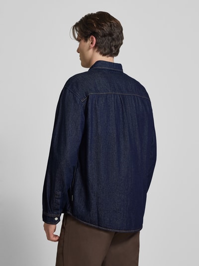Männermodel trägt Regular Fit Jeanshemd mit Kentkragen Modell 'NORREBRO' von Jack & Jones aus Reiner Baumwolle, dunkelblau, Rückenansicht.