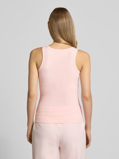 Männermodel trägt Slim Fit Top aus Viskose-Mix Modell 'Colette' von Guess Activewear, zartrosa, strukturierte Oberfläche, Ganzkörperansicht Rückansicht