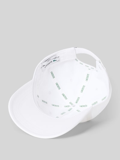 Produktfoto, Basecap aus reiner Baumwolle von Lacoste in Unifarbe Weiß mit Label Patch, feiner Webstruktur und Schnallenverschluss, Oberansicht.