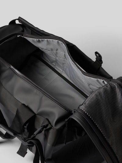 Produktfoto, Duffel Bag mit Logo-Detail Modell 'Texel' von Rains in Schwarz, sichtbares Hauptfach mit Reißverschluss und Schulterriemen, glatte und strukturierte Oberflächen, Kontext: Hauptfach mit Reißverschluss, verstellbare Schulterriemen, Breite 55 cm, Länge 26 cm, Tiefe 34 cm, Länge Schulterriemen 80 cm