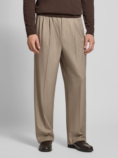 Männermodel trägt Straight Fit Hose mit Viskose-Anteil Modell 'Grant' von Casual Friday in Hellbraun mit Bügelfalten, Nahaufnahme Oberkörper, elastischer Bund sichtbar, Kontext: elastischer Material-Mix, Knopf- und Reißverschluss, Bundweite 43 cm, Innenbeinlänge 74 cm.
