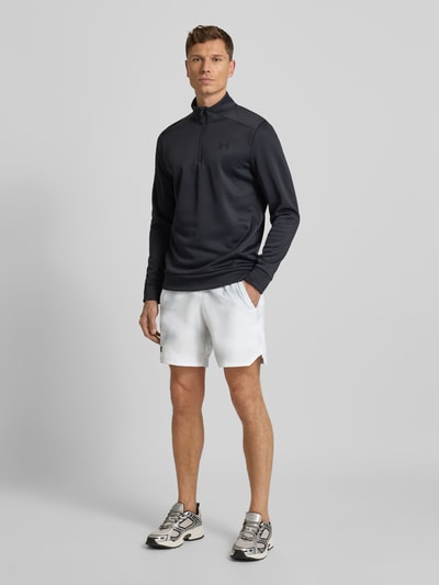 Männermodel trägt Shorts mit elastischem Bund von Under Armour, weiß, Label-Print, Französische Eingrifftaschen, Lockerer Schnitt, Ganzkörperansicht von vorne.