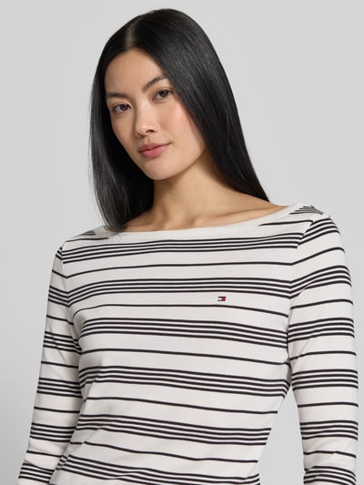 Frauenmodel trägt Slim Fit T-Shirt aus reiner Baumwolle von Tommy Hilfiger, weiß mit schwarzen Querstreifen, Damen T-Shirt, Nahaufnahme Oberkörper.