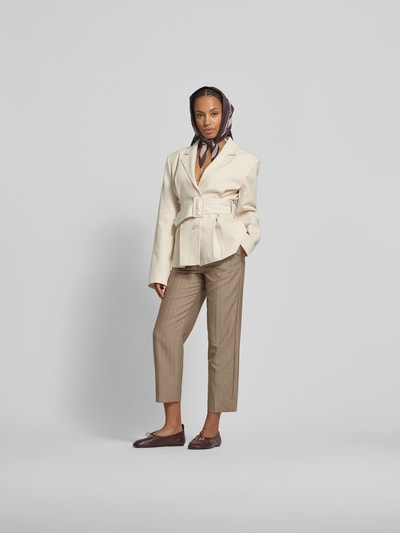 Frauenmodel trägt Leinenhose aus reinem Leinen von Victoria Beckham in Beige mit Bundfalten, Straight Fit, High-Waist, Ganzkörperansicht von vorne.