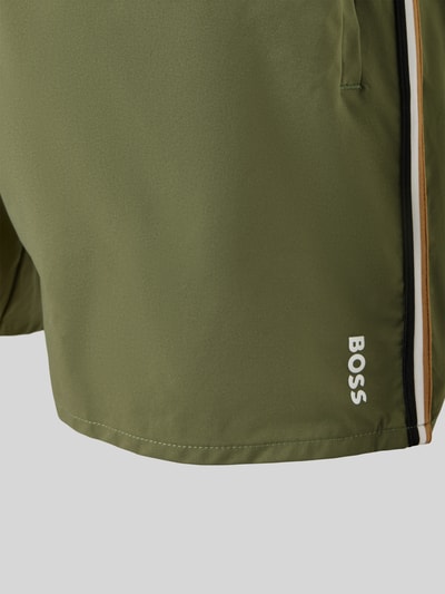 Produktfoto, Badeshorts mit Label Stitching Modell 'ICONIC' von BOSS, Optik: Unifarben, Label-Stitching, Label-Streifen, elastischer Bundabschluss, Tunnelzug, Gesäßtasche, seitliche Eingrifftaschen, Materialverarbeitung: Stretch-Webstruktur