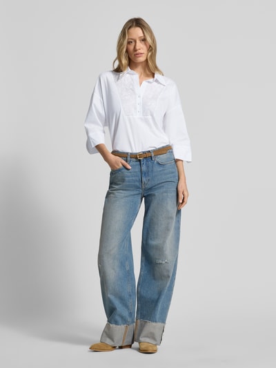 Frauenmodel trägt Blusenshirt mit 3/4-Arm von Marc Cain aus weißer Baumwolle, lockerer Schnitt, Umlegekragen, Ganzkörperansicht von vorne