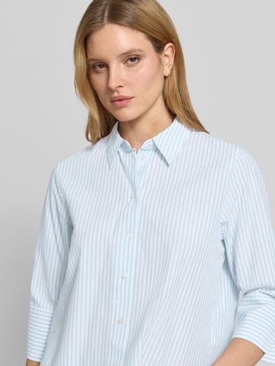 Frauenmodel trägt Regular Fit Hemdbluse aus Lyocell-Baumwoll-Mix von Tom Tailor, Popeline, hellblau-weiß gestreift, Nahaufnahme Oberkörper.