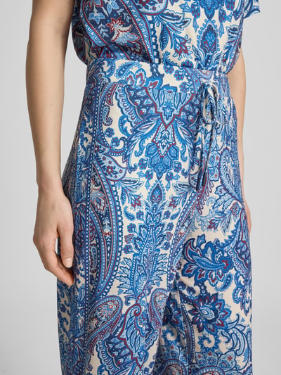 Frauenmodel trägt Hose im Allover-Look von Oui mit blauem Paisley-Muster, elastischem Bund und Tunnelzug, Nahaufnahme Oberkörper.