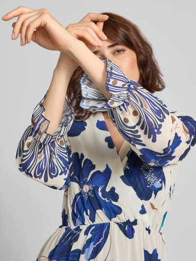 Frauenmodel trägt Knielanges Kleid im Allover-Look Modell 'Ja44milaa' von ZABAIONE in Blau-Weiß mit Chiffon, V-Ausschnitt. Nahaufnahme Oberkörper.