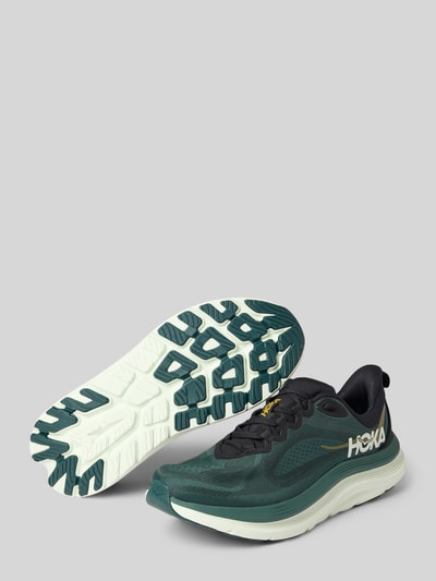 Produktfoto, Sneaker mit Label-Details und Schnürverschluss von HOKA aus Textil, abgerundete Form, profilierte Sohle, dunkelgrün-weiß