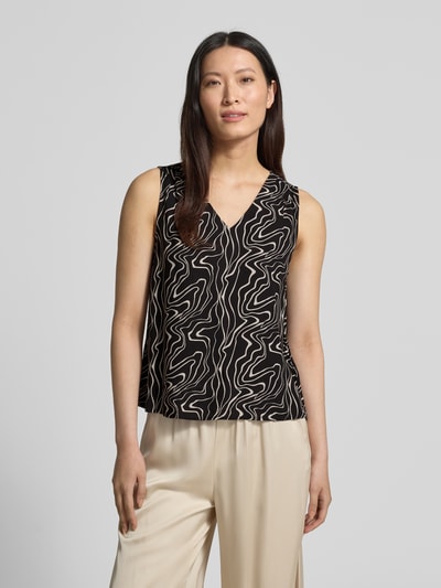 Vrouwenmodel draagt Loose Fit Top uit pure viscose model 'EASY JOY' van Vero Moda met alloverprint, V-hals, mouwloos, frontale lichaamsopname.