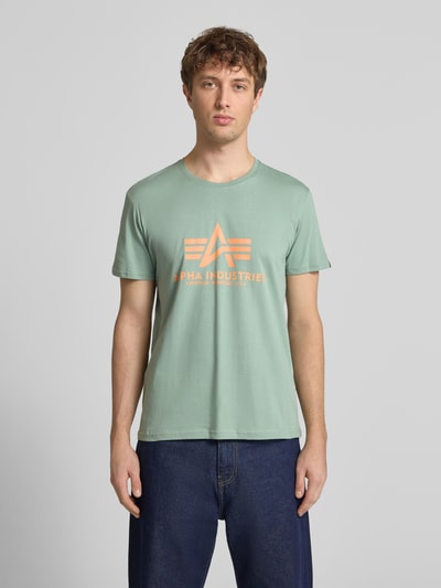 Mannelijk model draagt T-shirt met Label-Detail model 'BASIC' van Alpha Industries in mintgroen, puur katoen, recht model, ronde hals, ruglengte maat M 69 cm, voorkant opname, bovenlichaam close-up.