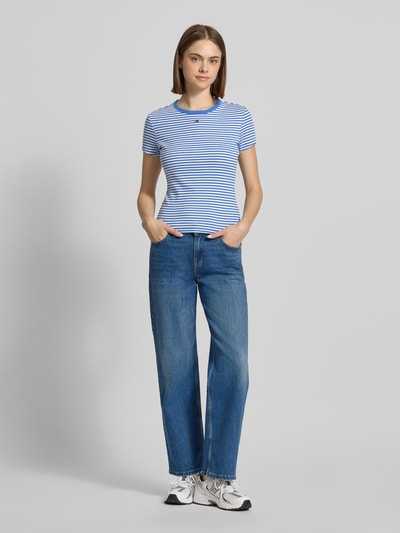 Frauenmodel trägt Slim Fit T-Shirts aus Baumwoll-Mix im 2-er-Pack von Tommy Jeans, mehrfarbig, Rundhals, kurzarm, Ganzkörperansicht von vorne.