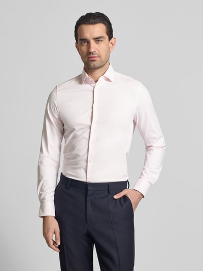 Männermodel trägt Slim Fit Business-Hemd mit Kentkragen von OLYMP Level Five aus elastischem Baumwoll-Mix, Ganzkörperansicht von vorne. Rückenlänge 78 cm, Schulterbreite 38 cm, Ärmellänge 68 cm, Knopfleiste, dezentes Hellrosa.