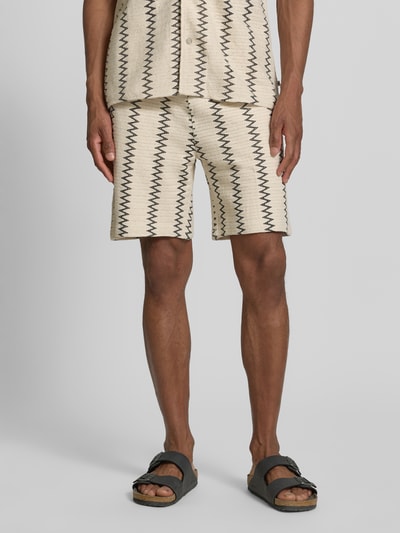 Männermodel trägt Relaxed Fit Stoffshorts aus Baumwoll-Mix von s.Oliver RED LABEL, Optik:Allover-Muster, Strukturmuster, Label-Patch, Material: reine Baumwolle, Nahaufnahme Unterkörper, Vorderansicht.