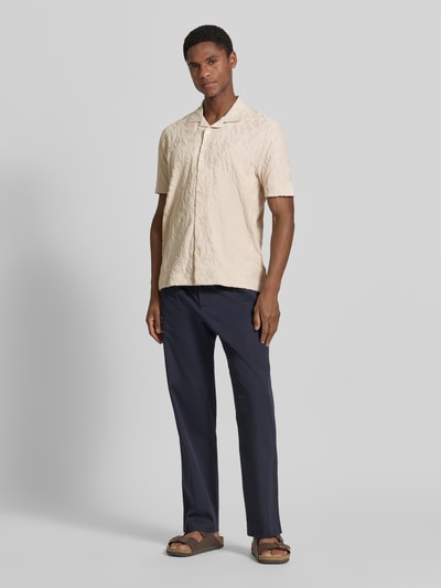 Männermodel trägt Regular Fit Freizeithemd aus reiner Baumwolle von Marc O'Polo in Optik: Unifarben mit Allover-Muster, Jacquard-Material, Resort-Kragen, durchgehender Knopfleiste, Label-Patch, Ärmelform: Kurzarm, Passform: Regular-Fit, Materialverarbeitung: Jacquard, Material: reine Baumwolle, Ganzkörperansicht von vorne.