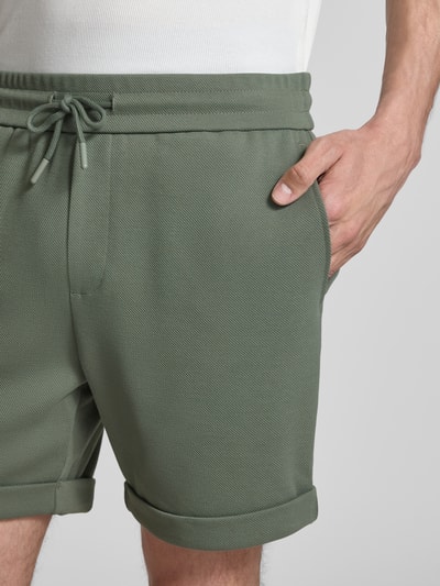 Männermodel trägt Regular Fit Shorts mit Viskose-Anteil Modell 'NEWKODYL' von Only & Sons, melierte Optik, Nadelstreifen, Nahaufnahme Oberkörper.