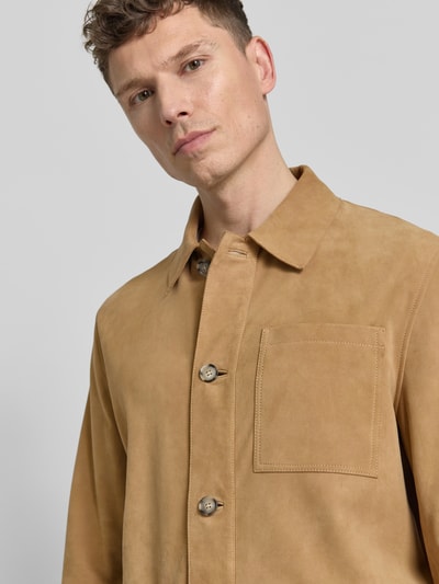 Männermodel trägt Lederjacke mit knoopsluiting en opgestikte zakken van Manuel Ritz in schapenleer, regular fit, platte kraag, nahaufnahme bovenlichaam.
