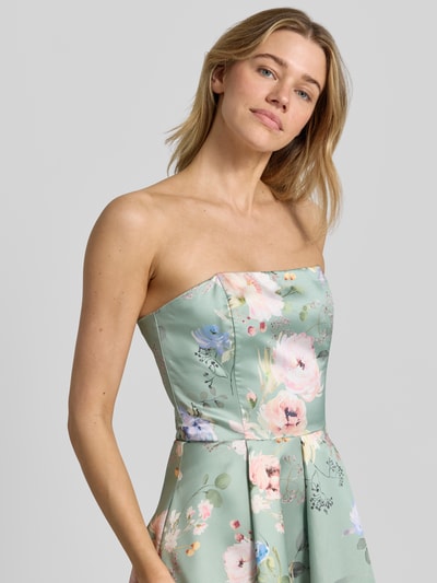 Modelka kobieca nosi sukienkę koktajlową im Off-Shoulder-Look od Swing, taliowany krój, sukienka midi, pastelowe kolory z kwiatowym wzorem, zamek błyskawiczny z tyłu, długość tyłu w rozmiarze 36: 98 cm, szerokość w rozmiarze 36: 41 cm, ujęcie z przodu, zbliżenie na górną część ciała.