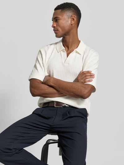 Männermodel trägt Relaxed Fit Poloshirt aus reiner Baumwolle von Marc O'Polo in Unifarben, Webstruktur, Polokragen, V-Ausschnitt, Nahaufnahme Oberkörper.