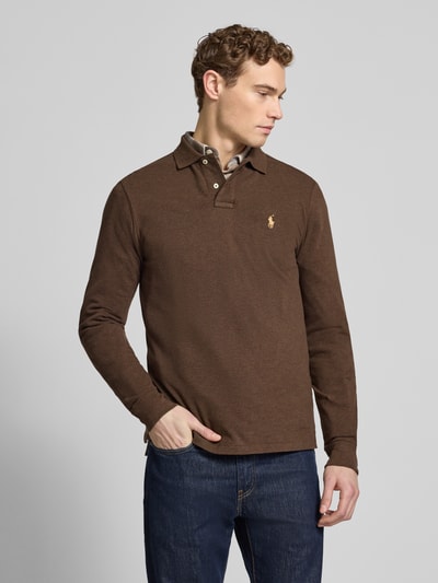 Männermodel trägt Slim Fit Poloshirt aus reiner Baumwolle von Polo Ralph Lauren, braun, unifarben, Piqué, Label-Stitching, Ganzkörperansicht von vorne.