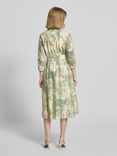 Frauenmodel trägt Figurumschmeichelndes Freizeitkleid aus Lyocell-Mix von s.Oliver BLACK LABEL mit Florales-Allover-Muster, Midi-Länge, V-Ausschnitt, Knopfleiste, Taillengürtel, 3/4-Arm, Materialverarbeitung: Popeline, Material: Viskose-Mix in zarten Grüntönen, Ganzkörperansicht Rückansicht.