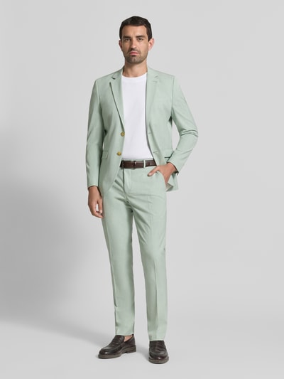Männermodel trägt Slim Fit Anzughose mit Viskose-Anteil Modell 'LIAM' von SELECTED HOMME in Melange-Optik, Ganzkörperansicht von vorne.