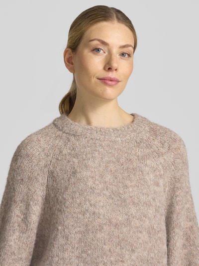 Vrouwenmodel draagt gebreide pullover met Raglanmouwen van FREE/QUENT, materiaalmix met wol, recht model, ronde hals, detailopname bovenlichaam.