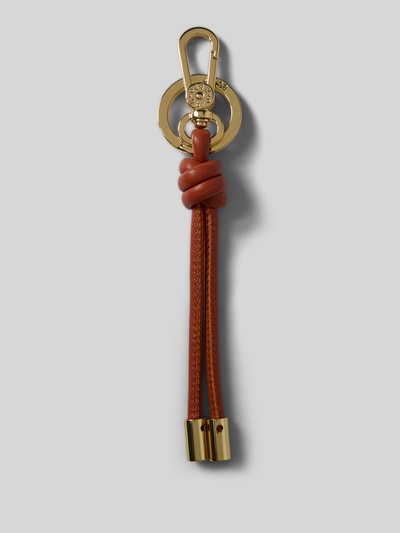 Productfoto, gouden en bruine 'Anhänger mit Knoten-Detail' van Abro met karabijnhaak, knoopdetail en labelprägung, gladde textuur.