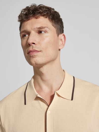 Männermodel trägt Regular Fit Freizeithemd in Strick-Optik Modell 'Apolo' von Matinique in Beige mit braunem Kragenrand, Nahaufnahme Oberkörper, Baumwoll-Mix, kurzärmelig.