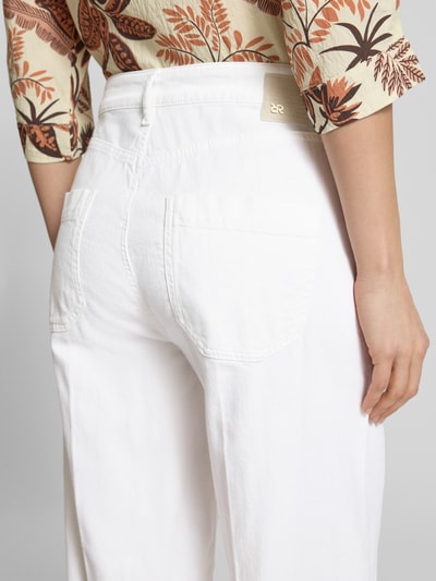 Männermodel trägt Wide Leg Jeans mit aufgesetzten Taschen Modell 'MIRU' von Raffaello Rossi, mieszanka bawełny i lnu, białe, nakładane kieszenie, długość 6/8, szerokość w rozmiarze 36: 41 cm, długość wewnętrzna nogawki: 65 cm, widok z tyłu zbliżenie na biodra.
