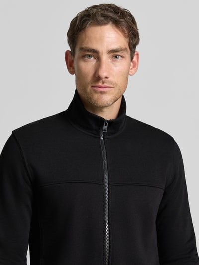 Männermodel trägt schwarze Regular Fit Sweatjacke aus Baumwoll-Mix von s.Oliver RED LABEL, Nahaufnahme Oberkörper.
