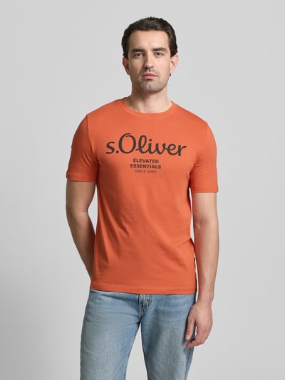 Männermodel trägt Regular Fit T-Shirt aus reiner Baumwolle von s.Oliver RED LABEL in Orange, unifarben, Rundhals, Kurzarm, Jersey, Ganzkörperansicht von vorne