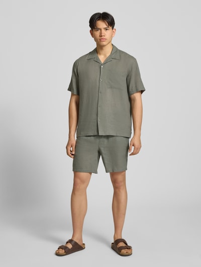 Männermodel trägt Relaxed Fit Freizeithemd aus Leinen-Viskose-Mix Modell 'LAURENCE' von Only & Sons in Optik: Unifarben, Passform: Relaxed-Fit, Reverskragen, einreihig, Ärmelform: Kurzarm, Brusttasche, Material: Leinen-Viskose-Mix, Ganzkörperansicht von vorne.