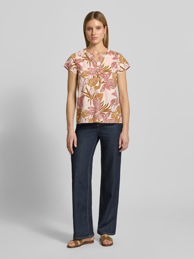 Frauenmodel trägt Relaxed Fit T-Shirt mit floralem Allover-Print von Soyaconcept aus reiner Baumwolle, Tunika-Ausschnitt, Ganzkörperansicht von vorne.