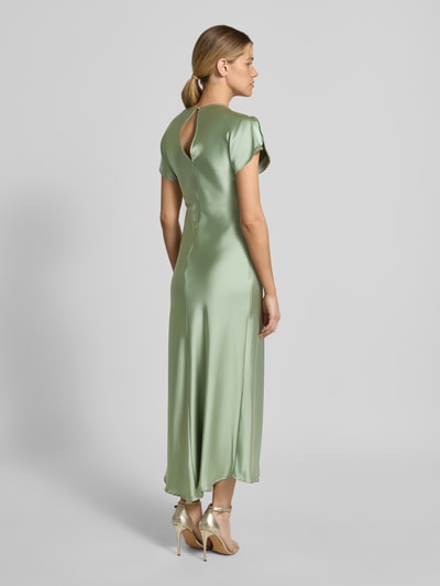 Frauenmodel trägt Cocktailkleid mit Rundhalsausschnitt Modell 'Miley' von GUIDO MARIA KRETSCHMER WOMAN, Midikleid aus grünem Satin, körpernaher Schnitt, Rückseitiger Schlüsselloch-Ausschnitt, Ärmel mit Schlitz, glatte Textur, Ganzkörperansicht Rückansicht.