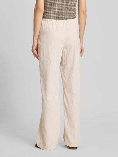 Frauenmodel trägt Wide Fit Stoffhose mit elastischem Bund Modell 'Poppy' von JJXX in Beige, glatte Textur, Ganzkörperansicht Rückansicht. Damen Stoffhose, elastischer Bund, Eingrifftaschen, Bundweite 36 cm, Innenbeinlänge 77 cm.