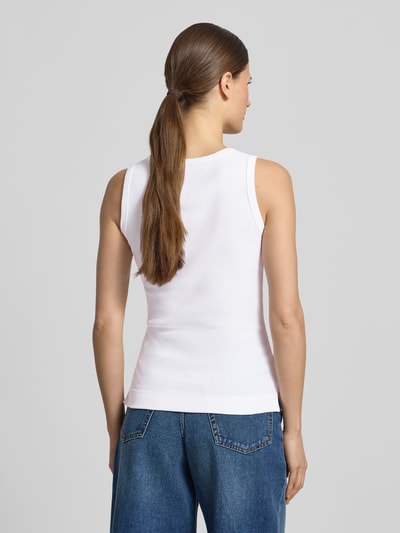 Modelka kobieca ma na sobie Tanktop in Ripp-Optik od JOOP!, bawełna z elastanem, krój slim fit, biała faktura prążków, widok całej sylwetki z tyłu.