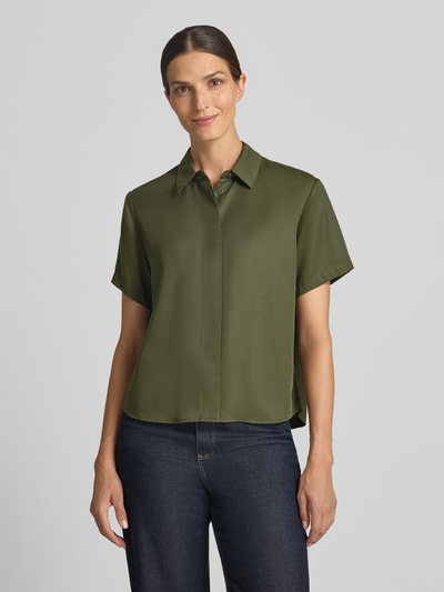 Frauenmodel trägt Relaxed Fit Bluse aus reinem Lyocell Modell 'Mina' von Samsøe Samsøe in Olivgrün, glatte Textur, Ganzkörperansicht von vorne.