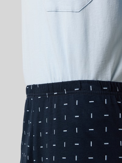Männermodel trägt Pyjama in minimalistischem Design von Schiesser in Blau und Weiß, reine Baumwolle, Nahaufnahme Oberkörper.