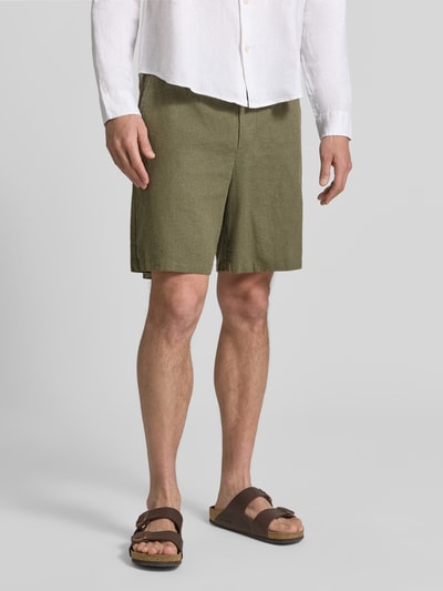Männermodel trägt Leinenshorts mit elastischem Bund von GAP aus Leinen-Baumwoll-Mix in Olive, Loose-Fit, mit Kordelzug, Eingrifftaschen, Gesäßtaschen, Ganzkörperansicht von vorne.