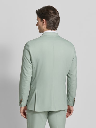 Männermodel trägt Slim Fit Anzugsakko mit Woll-Anteil Modell 'SLIM-NEIL' von SELECTED HOMME in Unifarben mit Rückenschlitz, Ganzkörperansicht Rückansicht.