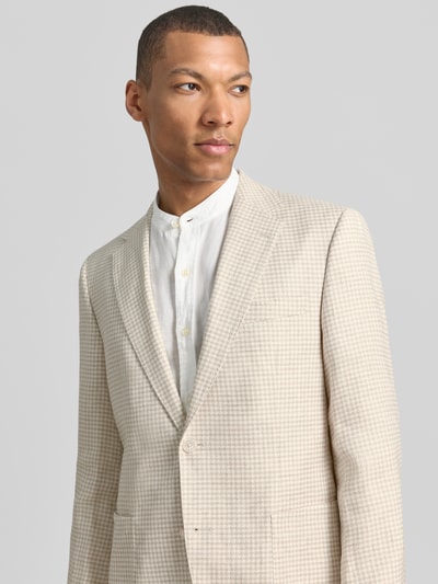 Männermodel trägt Regular Fit Sakko aus Leinen-Mix mit Seide-Anteil Modell 'H-JANSON-FL-261' von BOSS in Hahnentritt-Muster, Optik:Allover-Muster, Reverskragen, 2-Knopf-Verschluss, Kissing-Buttons, Brustleistentasche, aufgesetzte Eingrifftaschen, Innentasche, helle Farben, texturierte Oberfläche, Ganzkörperansicht von vorne.