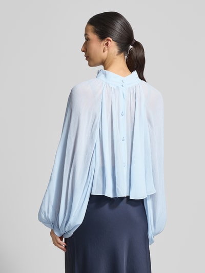 Frauenmodel trägt Loose Fit Langarmbluse aus reiner Viskose Modell 'AFFETTO' von MAX&Co., Optik: Unifarben, Relaxed-Fit, Stehkragen, Knopfleiste, Raglan-Ballonärmel, schmale Manschette, Materialverarbeitung: Crépon, Material: reine Viskose, in hellem Blau, texturierte, leicht transparente Oberfläche, Ganzkörperansicht Rückansicht.