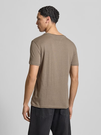 Männermodel trägt Slim Fit T-Shirt aus Baumwoll-Mix Modell 'JASPE HERITAGE' von Tommy Jeans in Melange-Optik, Ganzkörperansicht Rückansicht.
