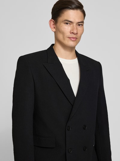 Männermodel trägt Slim Fit Anzugsakko aus Baumwoll-Mix Modell 'HENRY' von HUGO, Optik: Unifarben, Nahaufnahme Oberkörper.