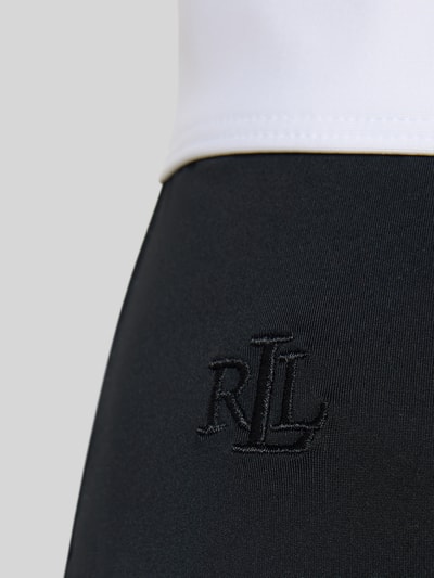 Vrouwenmodel draagt Bikini-Hose met elastische band van Lauren Ralph Lauren, tweekleurige look, applicatie met labelstitching, stretch geweven structuur, detailopname.