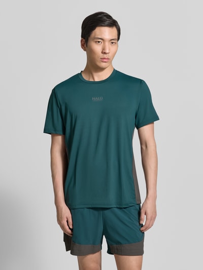 Männermodel trägt HALO Herren T-Shirt mit Logo Modell 'DIVISION', Material-Mix mit Stretch-Anteil, Regular-Fit, Rundhalsausschnitt, Farbe Dunkelgrün, Ganzkörperansicht von vorne.