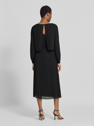Vrouwenmodel draagt A-linien vrijetijdsjurk met lange mouw van s.Oliver BLACK LABEL in zwart, plooien, Ganzkörperansicht Rückansicht.
